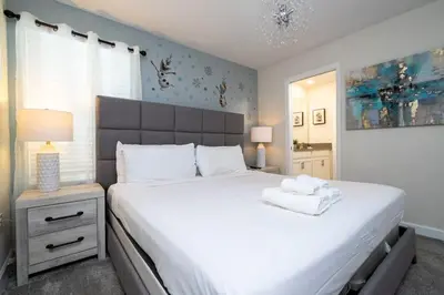 a bedroom with a large white bed and a window at Modern Marvel-Spacious, Themed, Fun-Filled in Kissimmee