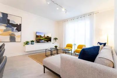 a living room with a couch and a table at Chic Modern Marvel, Themed Beds, Private Pool in Kissimmee