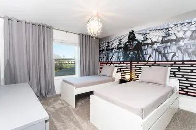 a room with two beds and a couch and a window at Chic Modern Marvel, Themed Beds, Private Pool in Kissimmee