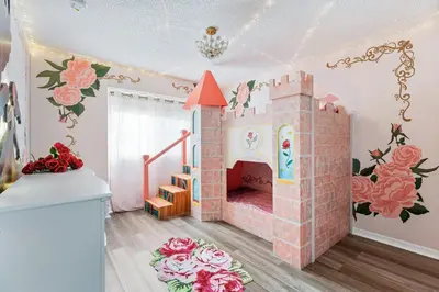 a childs room with a pink castle on the wall at 5BR Themed Pool Home Near Disney World in Kissimmee