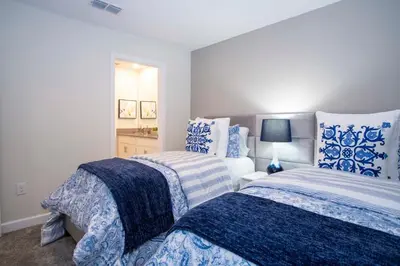 a bedroom with two beds with blue and white at Storey Lake House 2713 in Kissimmee