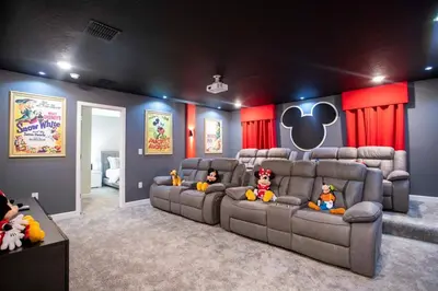 a living room with a large couch and a movie theater at Storey Lake House 2713 in Kissimmee