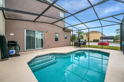 a swimming pool in a house with a glass ceiling at Remodeled Gem - Comfort & Location in Kissimmee