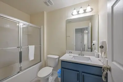 a bathroom with a toilet and a sink and a shower at Remodeled Gem - Comfort & Location in Kissimmee