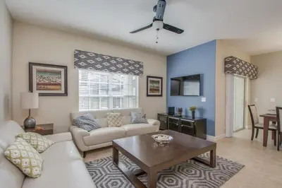 a living room with a couch and a table at Prime Locale - Vacation Paradise in Kissimmee