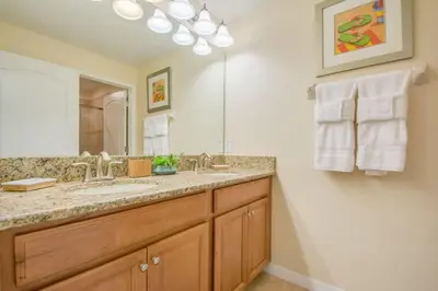 a bathroom with a sink and a mirror at Prime Locale - Vacation Paradise in Kissimmee