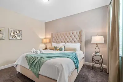 a bedroom with a large bed with a large headboard at 8 Bd home with Themed rooms and Pool 2308 in Orlando