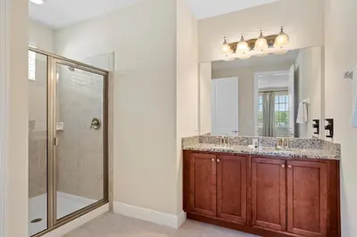 a bathroom with a shower and a sink and a mirror at 8 Bd home with Themed rooms and Pool 2308 in Orlando