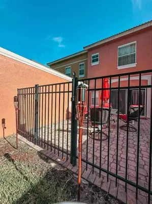 a iron fence in front of a building at Roomy House Near Disney with Resort Pool and Patio BBQ in Kissimmee