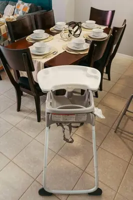 a dining room table with a white chair in front of it at Roomy House Near Disney with Resort Pool and Patio BBQ in Kissimmee