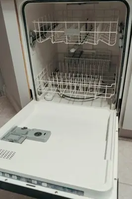 a dishwasher with a dish rack in it at Roomy House Near Disney with Resort Pool and Patio BBQ in Kissimmee