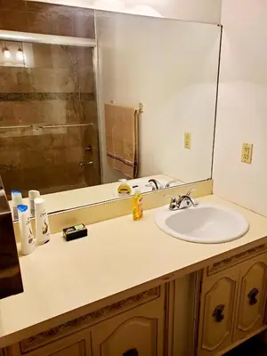a bathroom with a sink and a mirror at The Farm House in Sanford
