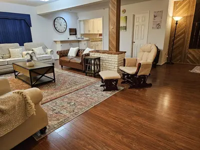 a living room with couches and chairs and a table at The Farm House in Sanford