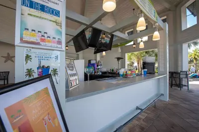 a bar in a building with a bar counter at Storey Lake: Apartment with lake view in Kissimmee