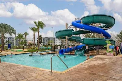 a water slide in a pool at a resort at Townhome with pool at Storey Lake in Kissimmee