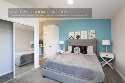 a bedroom with a king bed and a mirror at Stunning 3BD Condo 14 Mins to Disney World , Gated in Kissimmee