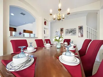 a dining room with a table and red chairs at Golden Beach Villa home in Kissimmee