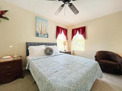 a bedroom with a bed and a ceiling fan at Golden Beach Villa home in Kissimmee