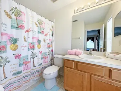 a bathroom with a toilet and a sink and a mirror at Golden Beach Villa home in Kissimmee
