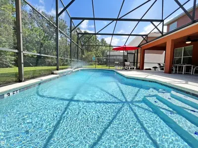 a swimming pool with blue water in a house at Golden Beach Villa home in Kissimmee