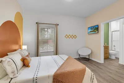 a bedroom with a large bed and a window at Remarkable Cozy 4Bed-3Ba Townhouse in Kissimmee