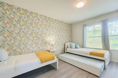 a bedroom with two beds and a window at Remarkable Cozy 4Bed-3Ba Townhouse in Kissimmee