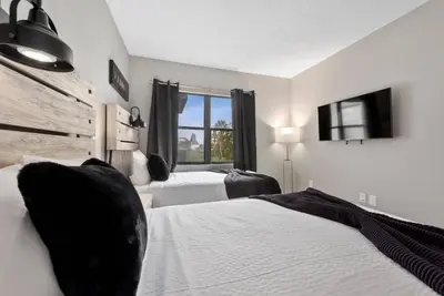 a bedroom with two beds and a window at Apartment with Volcano Bay view in Orlando