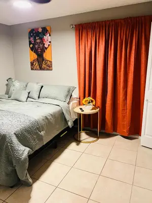 a bedroom with a bed and a table next to a window at 2bdrm Home near Orl Fairgrd, Downtwn, Wekiva Sprng in Orlando