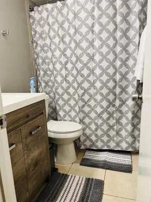 a bathroom with a toilet and a shower curtain at 2bdrm Home near Orl Fairgrd, Downtwn, Wekiva Sprng in Orlando