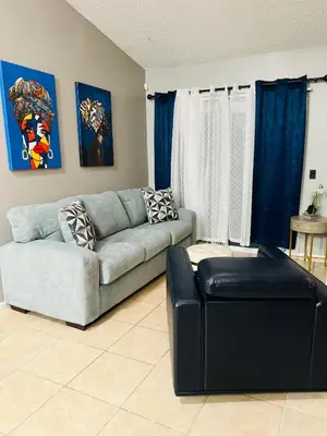a living room with a couch and a chair at 2bdrm Home near Orl Fairgrd, Downtwn, Wekiva Sprng in Orlando