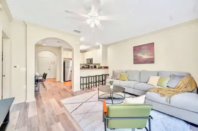 a living room with a couch and a table at Modern 2BR Condo - Pool - Near Disney in Orlando