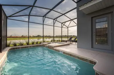 a swimming pool in a house with a glass roof at Luxury 5BR Home, Private Pool, Prime Location in Kissimmee
