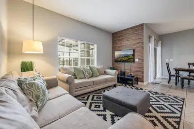 a living room with two couches and a table at Cozy Home Near Disney Parks - Prime Location in Kissimmee