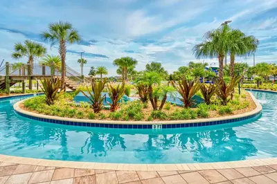 a pool at a resort with palm trees at Cozy Home Prime Disney Parks Location in Kissimmee