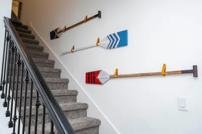a staircase with umbrellas hanging on a wall at Vibrant Themed Home Prime Location in Kissimmee