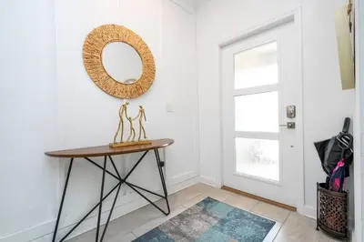 a room with a table and a mirror on the wall at Vibrant Themed Home Prime Location in Kissimmee
