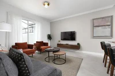 a living room with a couch and chairs and a tv at Modern Chic-Spacious, Private Pool, Prime Location in Kissimmee
