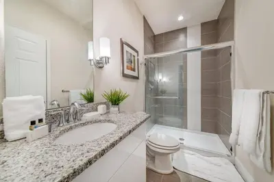 a bathroom with a sink and a toilet and a shower at Cozy Villa Private Pool Prime Spot in Orlando