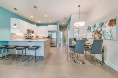 a kitchen and dining room with a table and chairs at Cozy Villa Private Pool Prime Spot in Orlando