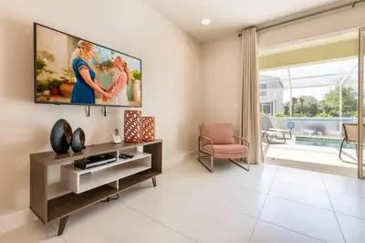 a living room with a large tv on the wall at Spacious Comfortable Perfect Vacation in Orlando