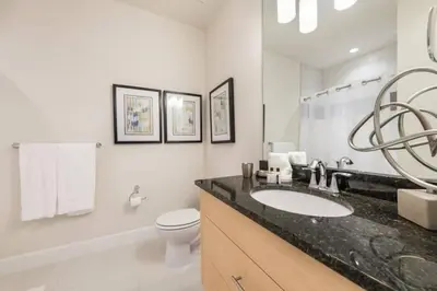 a white bathroom with a sink and a toilet at Spacious Comfortable Perfect Vacation in Orlando