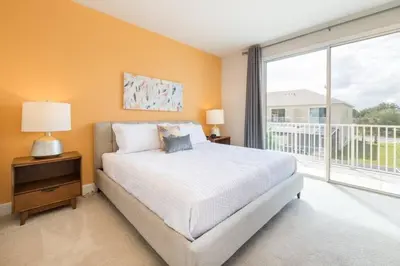 a bedroom with a bed and a large window at Spacious Comfortable Perfect Vacation in Orlando