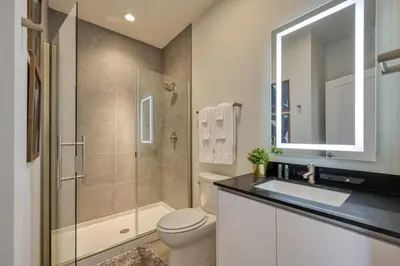 a bathroom with a toilet and a sink and a shower at Modern Luxury Retreat - Mickey & Harry Potter Beds in Orlando