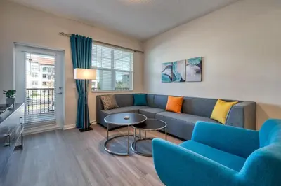 a living room with a couch and a table at Prime Location-Spacious Condo for 8 Guests in Orlando