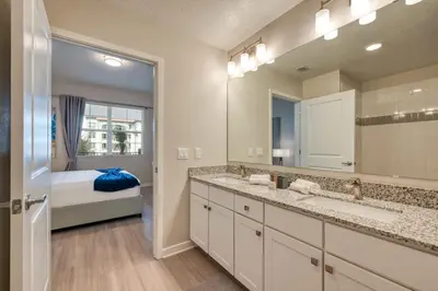 a bathroom with two sinks and a large mirror at Leisure & Business Oasis-Near Convention Center in Orlando