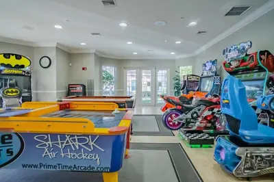 a room with a pool table and arcade games at Leisure & Business Oasis-Near Convention Center in Orlando