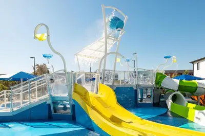 a water park with a slide in the water at Villatel Orlando Resort in Orlando