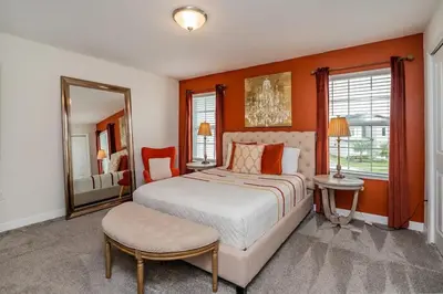 a bedroom with a large bed and a mirror at Vacation Bliss-Prime Resort Unbeatable Location in Kissimmee