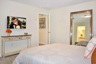 a bedroom with a bed and a tv on the wall at Vacation Bliss-Prime Resort Unbeatable Location in Kissimmee