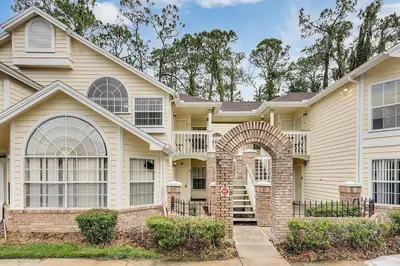a house with an archway in front of it at Gorgeous Place Minutes Away from Attractions in Kissimmee